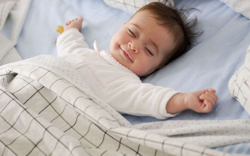 Baby asleep smiling
